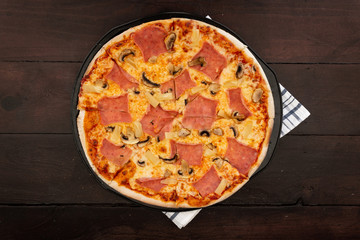 Italian pizza over wooden vintage table