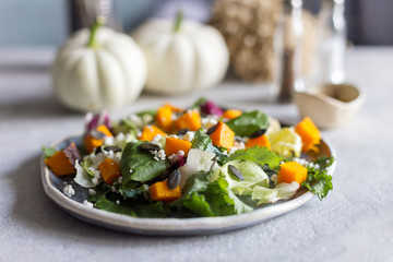 Salad with pumpkin and cheese on plate