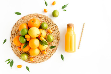 Background made of summer tropical fruits: orange, lemon, lime and juice on white background. Food, drink concept. Flat lay, top view summer concept.