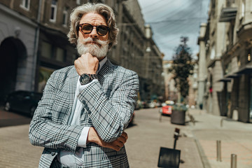 Handsome stylish gentleman standing on the street