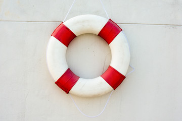 Safety equipment, Life buoy or rescue buoy floating on swimming pool to rescue people from drowning man.