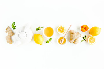 Herbal tea with mint, ginger, lemon, honey and other herbs on white background. Flat lay, top view.