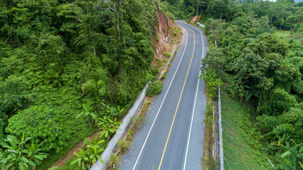 Fototapeta na wymiar Asphalt road curve in high mountain image by Drone