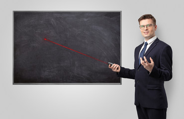 Handsome young teacher with laser pointer teaching
