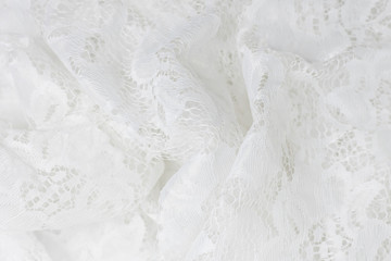 Obraz premium Wrinkled lace fabric cute white color, fragment closeup.