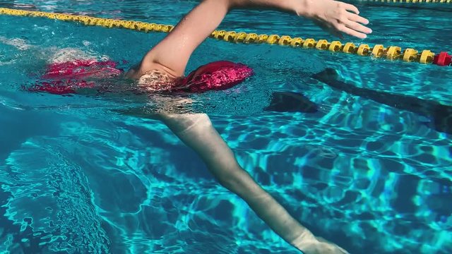 young woman swimming freestyle