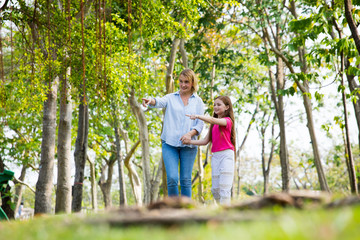 Fototapeta premium Mother and son walk in the park . Happy family concept