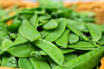 Fresh green peas piled on the market. Food backgroumd. Harvest