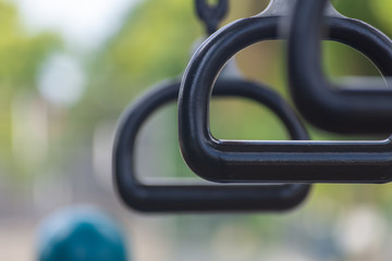 Empty monkey bars at a playground conecept looking through at goals and holding on strong preventing falling and maintaining balance.