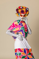 Catrina makeup. Young Mexican woman with typical costume.