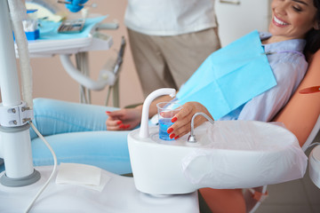 Male dentist is preparing for dental procedure