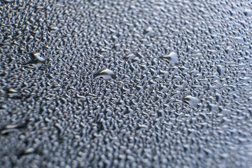 drop of water on a car glass. abstraction pattern