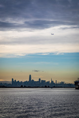 Plane flying over San Francisco skyline close to sunset