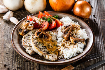 Grilled pork chop with white rice and mushroomson
