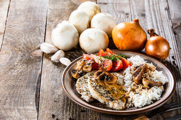 Grilled pork chop with white rice and mushroomson