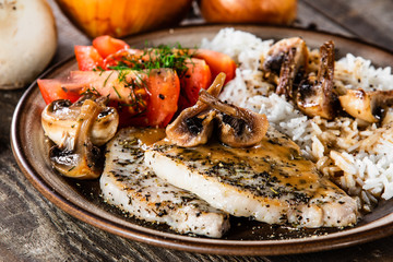 Grilled pork chop with white rice and mushroomson