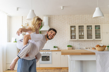 Happy man and woman having fun in the apartment