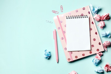 Pink notebook on a blue background with school supplies. Back to school. Teacher's Day.