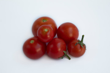 Tomatoes and grapes. Close-up. Isolated on a gray background. There is a place for text.
