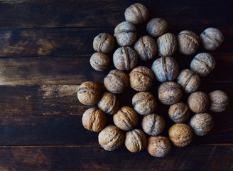 walnuts in a shell on a wooden table