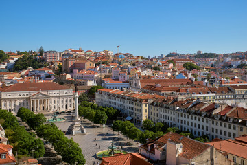 Fototapeta na wymiar Panoramic aerial view over Rossio square, Pedro IV square, with Column of Pedro IV, National Theater, fountains and historical buildings, surrounding square, on hot summer day. Lisbon, Portugal.