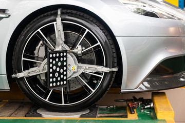 Fototapeta na wymiar Car wheel clamp with wheel align device for wheel alignment