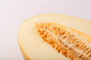 Big melon divided into slices. Seeds and pulp close-up