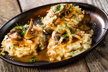 Potato cakes with gravy sauce and champignon