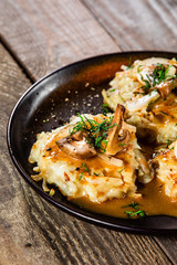 Potato cakes with gravy sauce and champignon