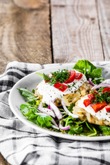 Potato cakes with sour cream and vegetables