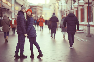 young man and woman hugging kissing outside