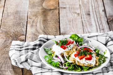 Potato cakes with sour cream and vegetables