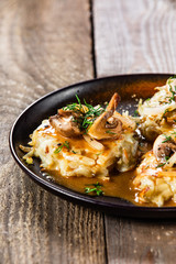 Potato cakes with gravy sauce and champignon