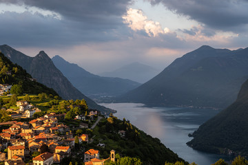 Dramtatic sunset over the Bre village and mountain by lake lugano in Ticino canton in Switzerland