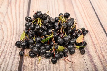 Ripe berries Aronia pile lie on the table
