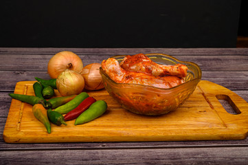 Chicken legs marinated with spices for frying