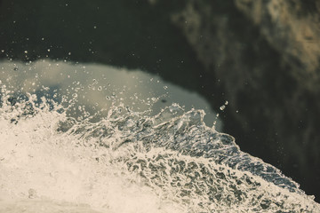 Splash of fresh water with drops caught in the air with turquoise river surface in the background  