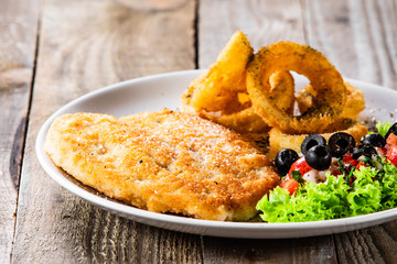 Fried pork chop, onion rings and vegetables