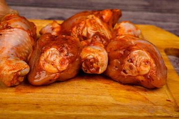 Chicken legs marinated with spices for frying