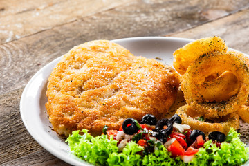 Fried pork chop, onion rings and vegetables
