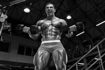 Fototapeta na wymiar Bodybuilder Workout in the Gym, doing Biceps Exercise.Black and White Image