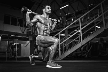 Fototapeta na wymiar Bodybuilder Doing Lunges, Leg Exercise at the Gym
