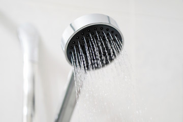 Shower head with water stream. Modern shower head in modern bathroom. Shower head with refreshing...