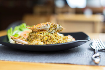 Fried rice with crab on dish with spoon/Crab fried rice with curry powder,onion/Kao pad poo/