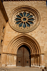 Obraz premium Glass and stone rosette, and door. Front view in a monsatery.
