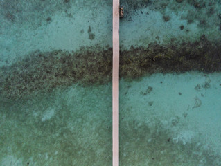 Jetty for boats in a Maldivian atoll seen from above - aerial view