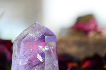 Beautiful Amethyst tower, lots of rainbows. Beautiful polished amethyst tower. Bright Quartz crystal, healing crystal being held in hand. Woman holding amethyst tower, natural lighting, reiki energy