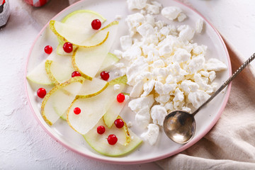Fototapeta na wymiar Breakfast with coffee. cottage cheese with slices of pear, Apple and cranberries