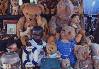 Old bears and toys on the stand for sale, welcome aboard