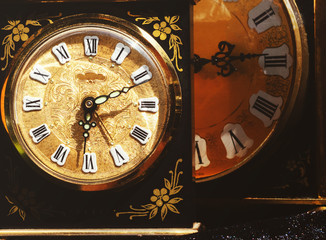 Old table clock on a black background